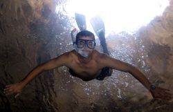 Rambo - duck dive in natural cavern. by John M Akar 